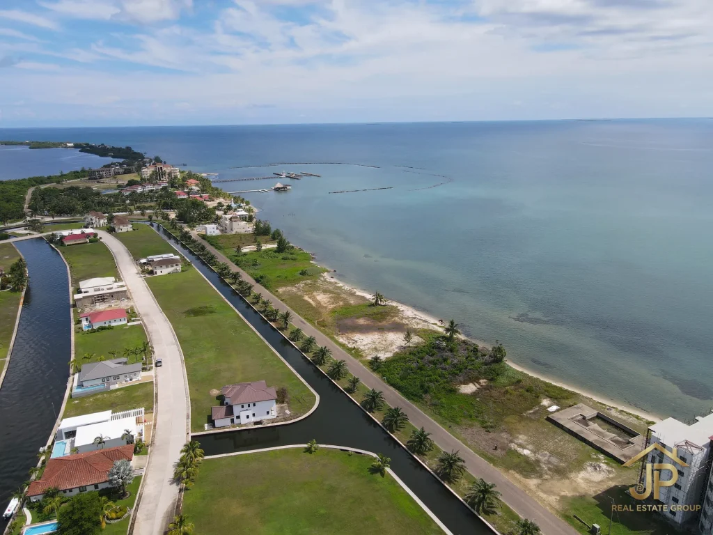 Placencia Peninsula beachfront property aerial view with turquoise water - JP Real Estate Group