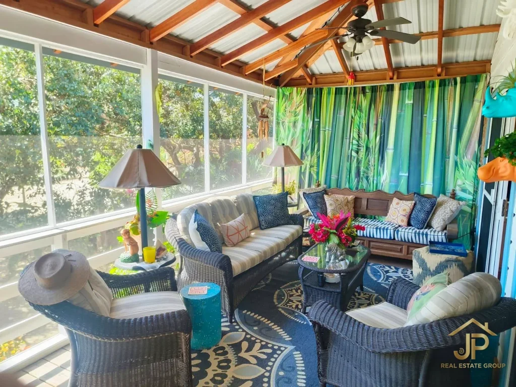 Open living room with wood ceiling in Kokomo Belize home