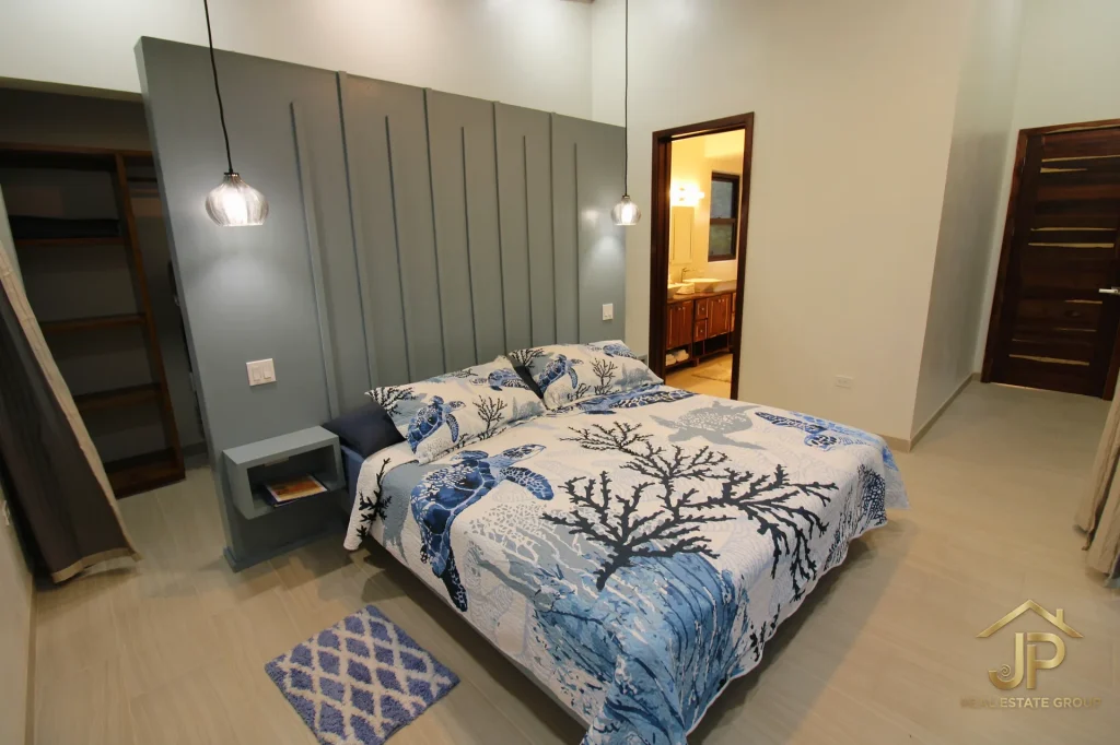 Primary bedroom with pool access at Naia Belize home
