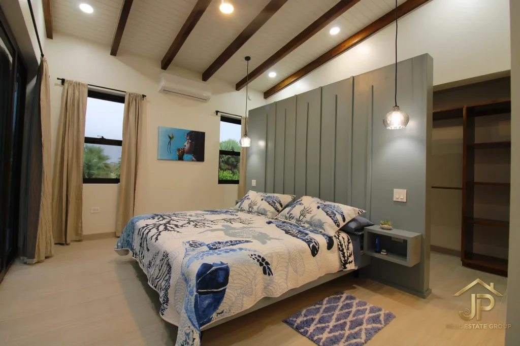 Bedroom with wood accent wall at Naia waterfront residence