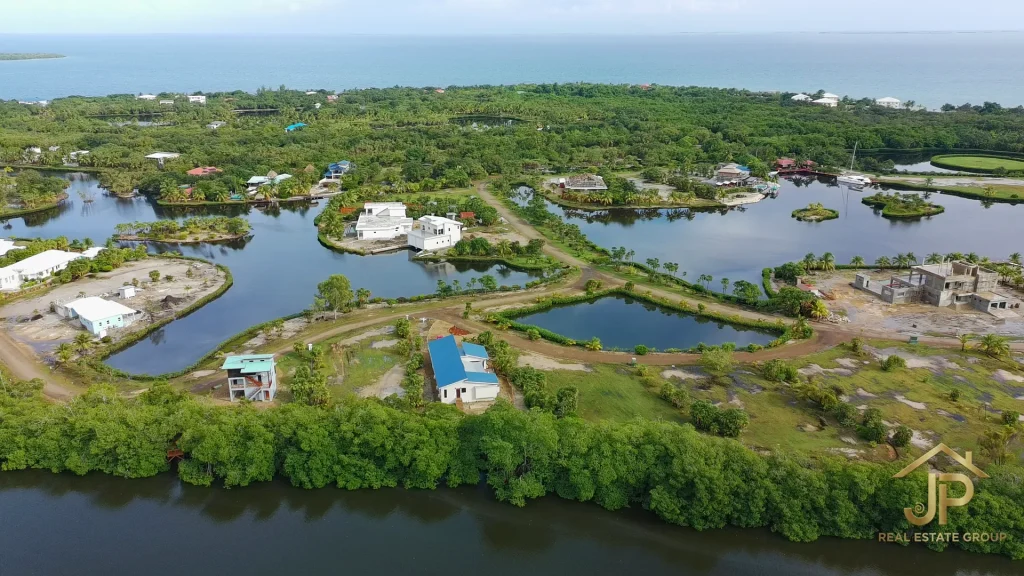 Drone view of Naia home, garage, and lagoon setting