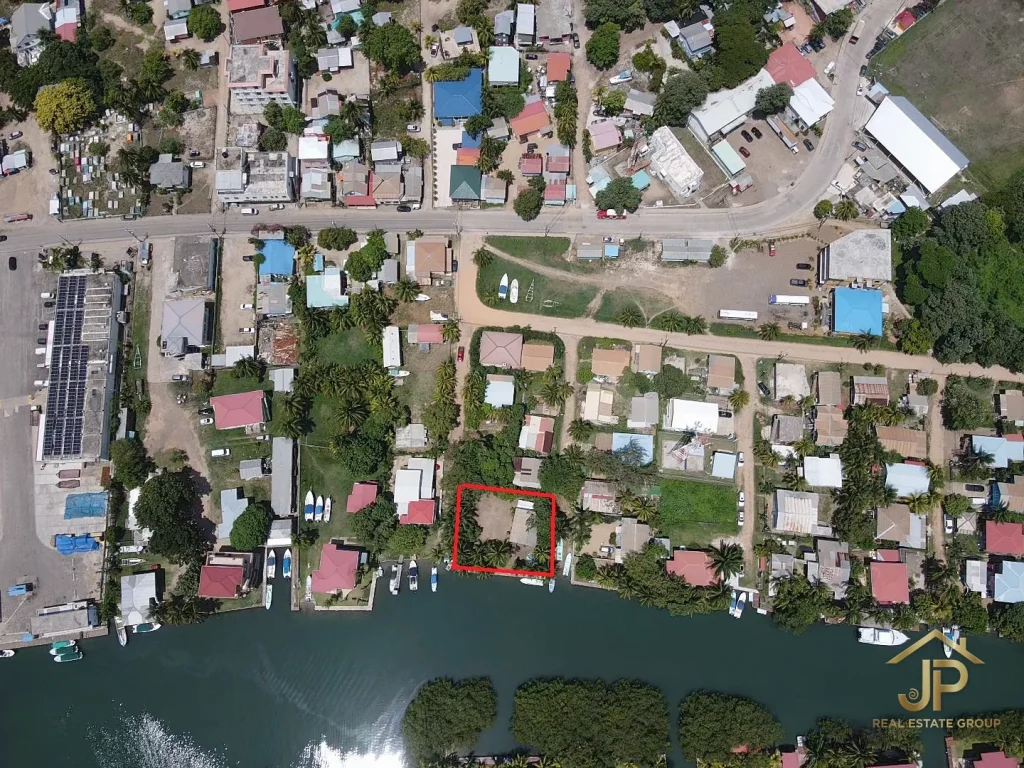 waterfront duplex in Placencia Village Belize with canal and village context - JP Real Estate Group