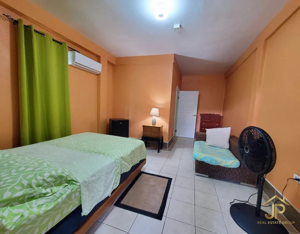 Second view of furnished guest bedroom in Placencia Village hotel