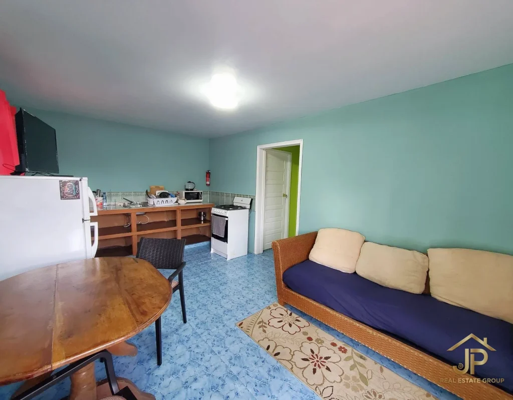 Guest bedroom with green walls at Placencia hospitality property