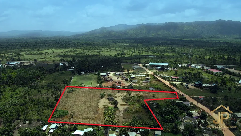 Aerial view of the 5-acre Santa Cruz Village property boundary with mountain backdrop