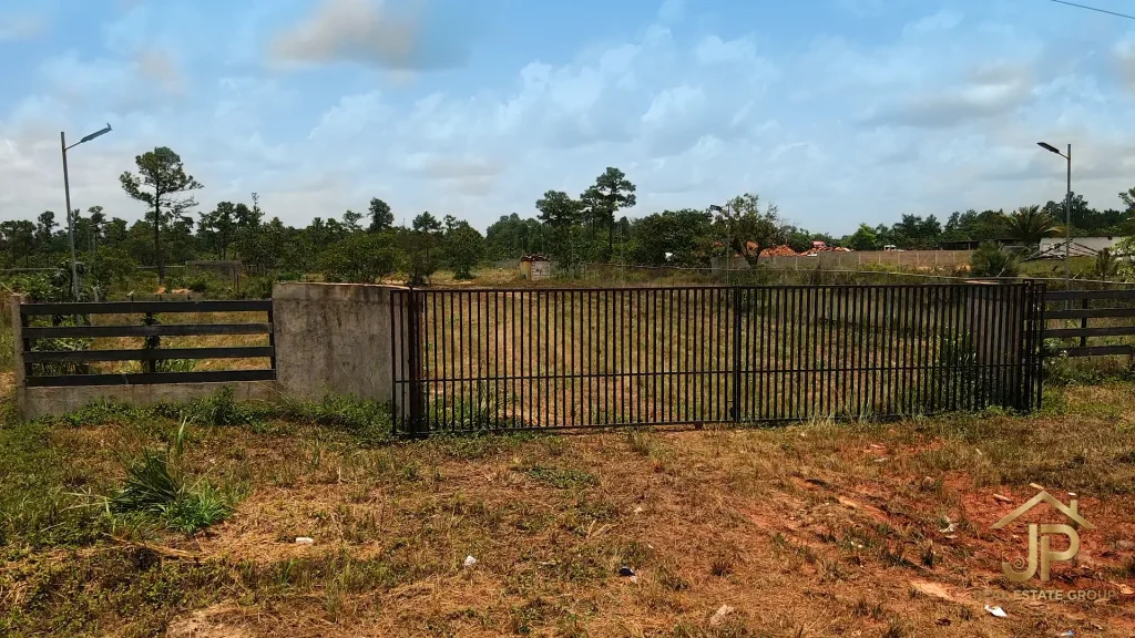 Gated entrance to the fenced 5-acre property in Santa Cruz Village