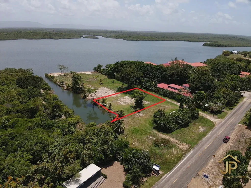 Maya Beach canal lot aerial view with boat basin and Placencia Lagoon behind - JP Real Estate Group