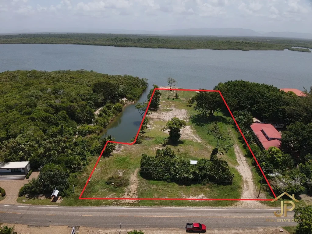 lagoon front lots for sale in Placencia Belize aerial view of parcel with lagoon and canal - JP Real Estate Group