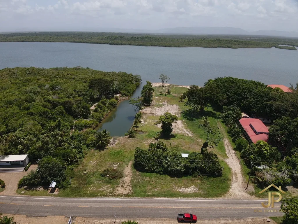 Placencia lagoon front property Maya Beach aerial view from road with canal and lagoon - JP Real Estate Group