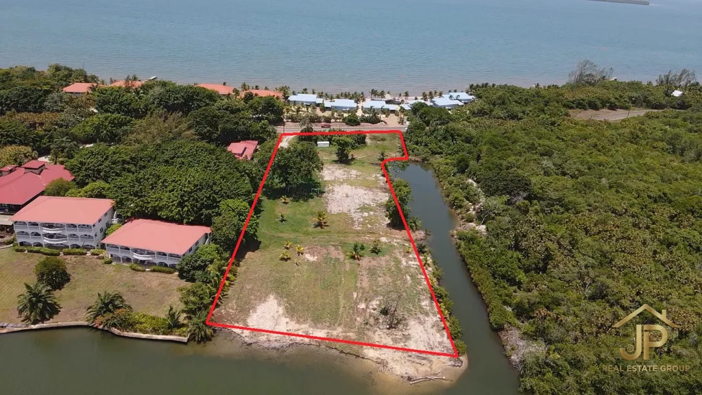 waterfront development land for sale in Maya Beach Placencia aerial view with Caribbean Sea and marked 2.3 acre parcel - JP Real Estate Group