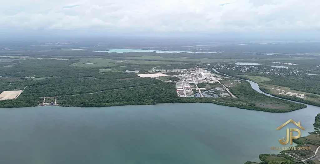Wide aerial view of a lagoon and the surrounding Corozal landscape