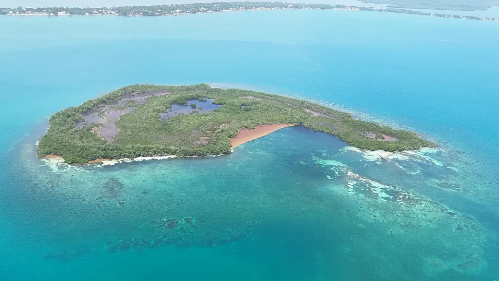 Aerial view of the 43-acre island and surrounding Caribbean waters near Placencia