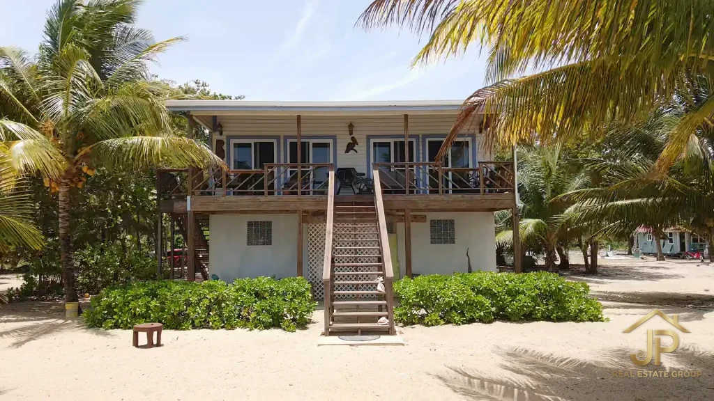 Beachfront main house with coconut palms and direct shoreline