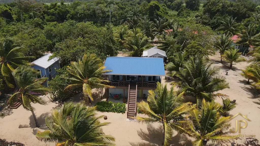 Main residence and guest casita among landscaped coconut palms