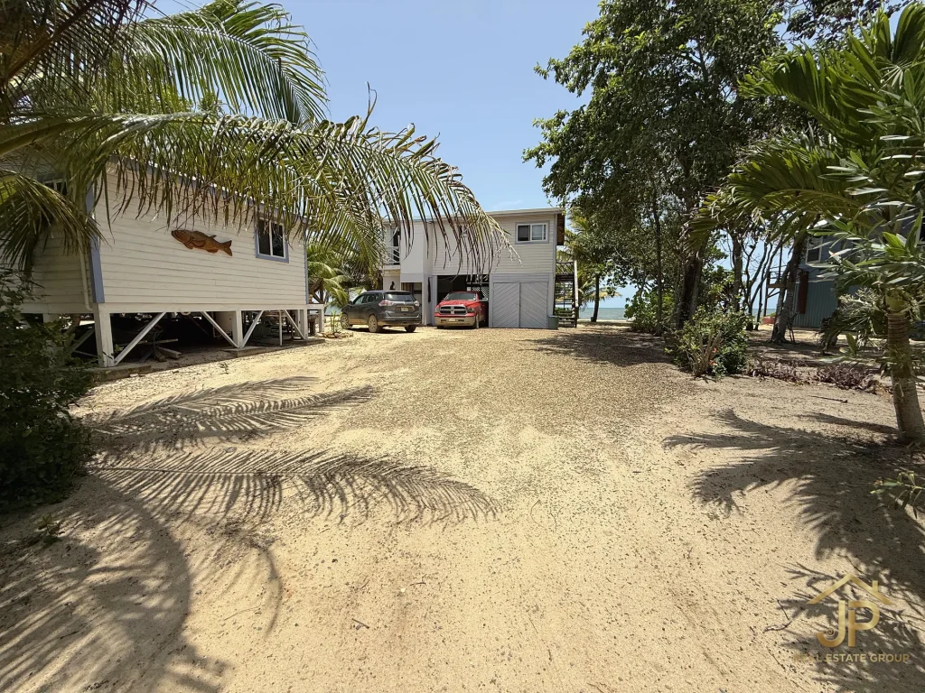 Ground-level arrival view of the Mayacan beachfront home and guest casita